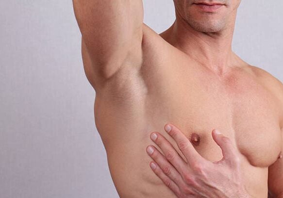 Close up of muscular male torso, chest and armpit hair removal. Male Waxing